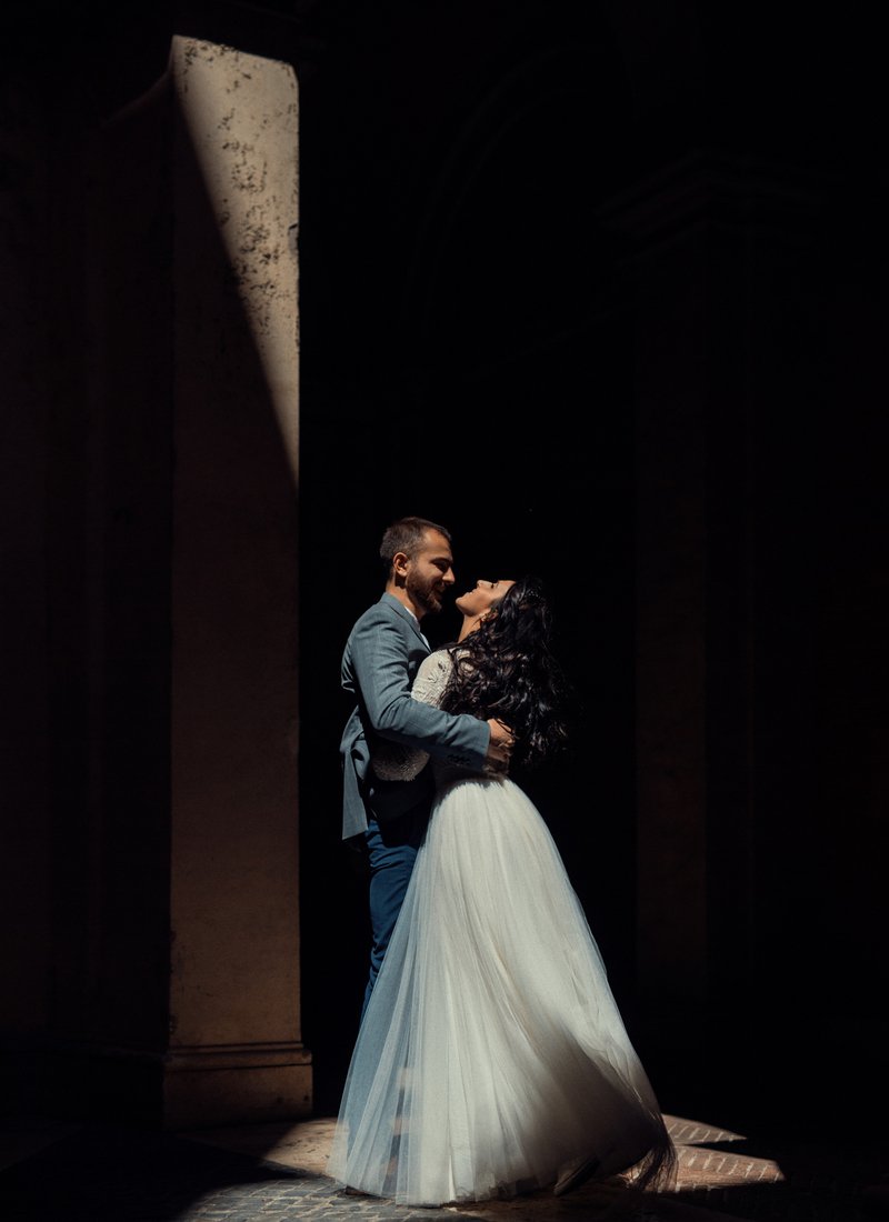 Bride and Groom Embracing in Dramatic Light