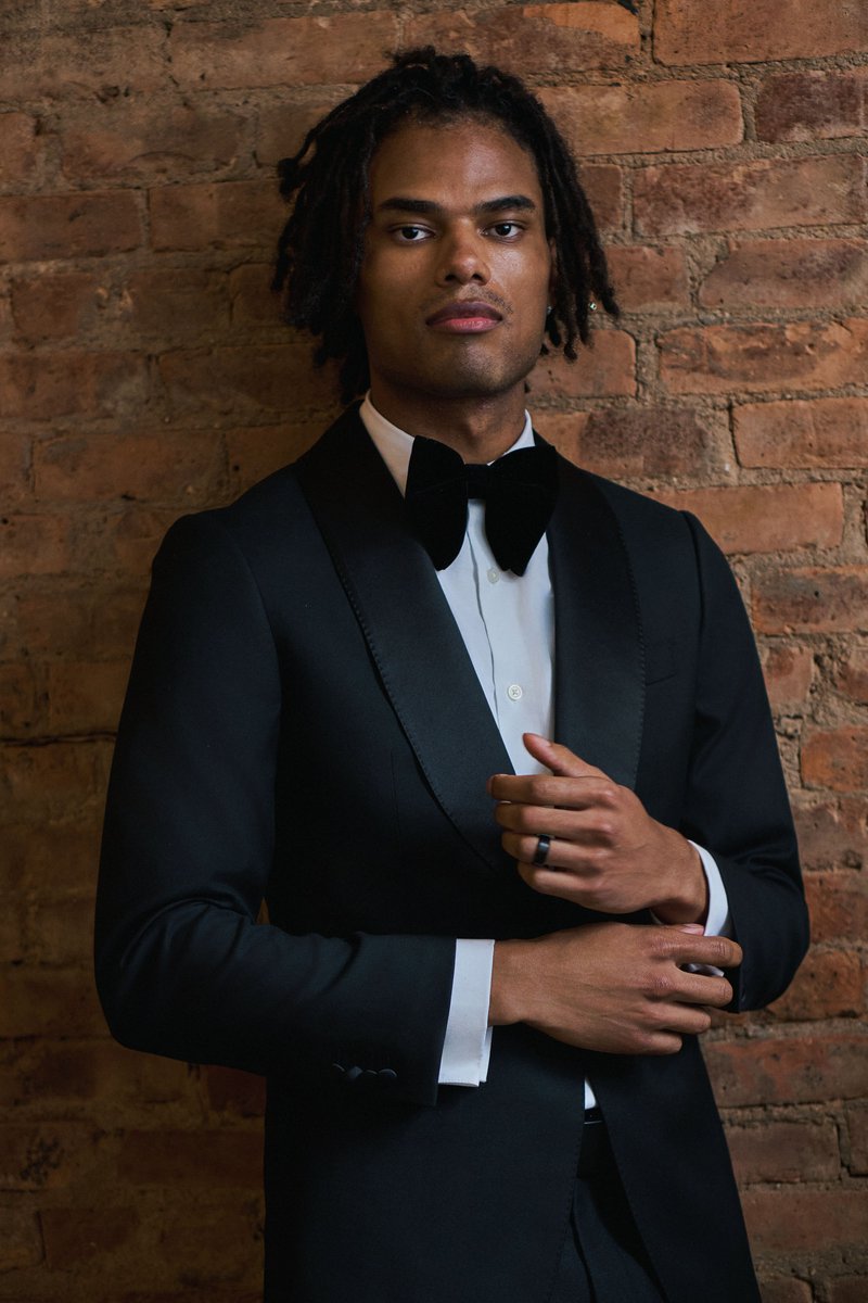 Groom in a Tuxedo Against an Exposed Brick Wall