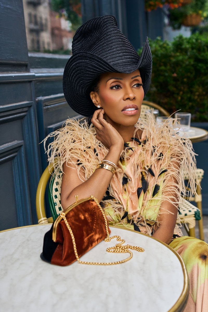 Woman in a Wide-Brim Hat at a Manhattan Sidewalk Cafe