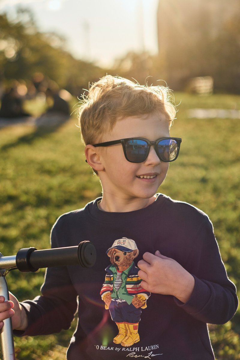 Boy on a Scooter in a Sunlit Park