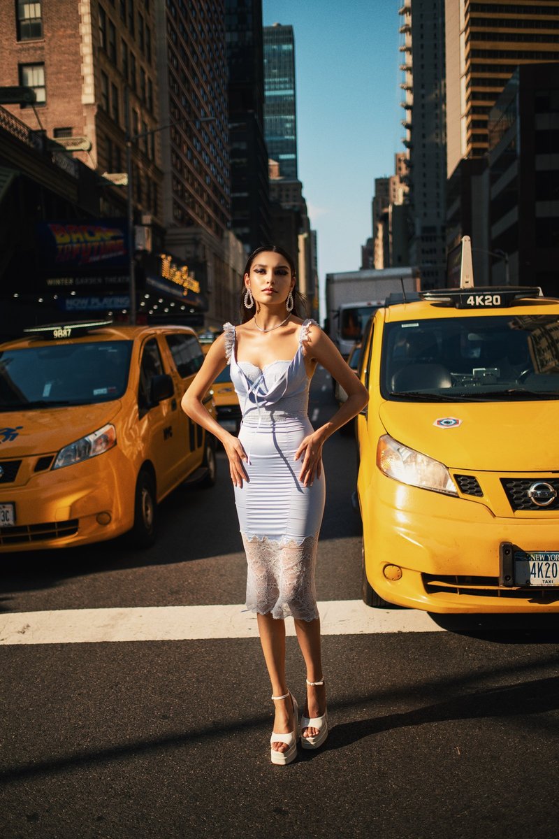 Model Between Yellow Taxis in Midtown Manhattan