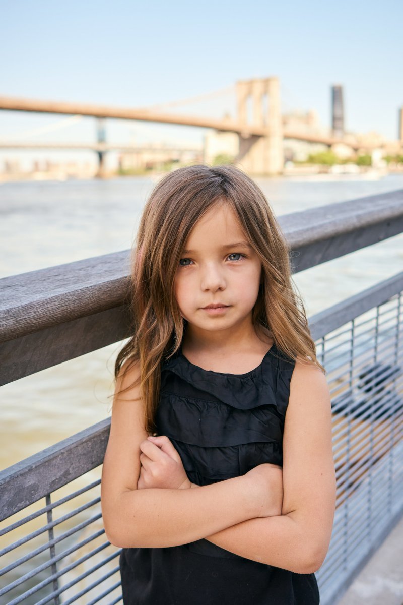 Girl on the Seaport Boardwalk with the Brooklyn Bridge Behind