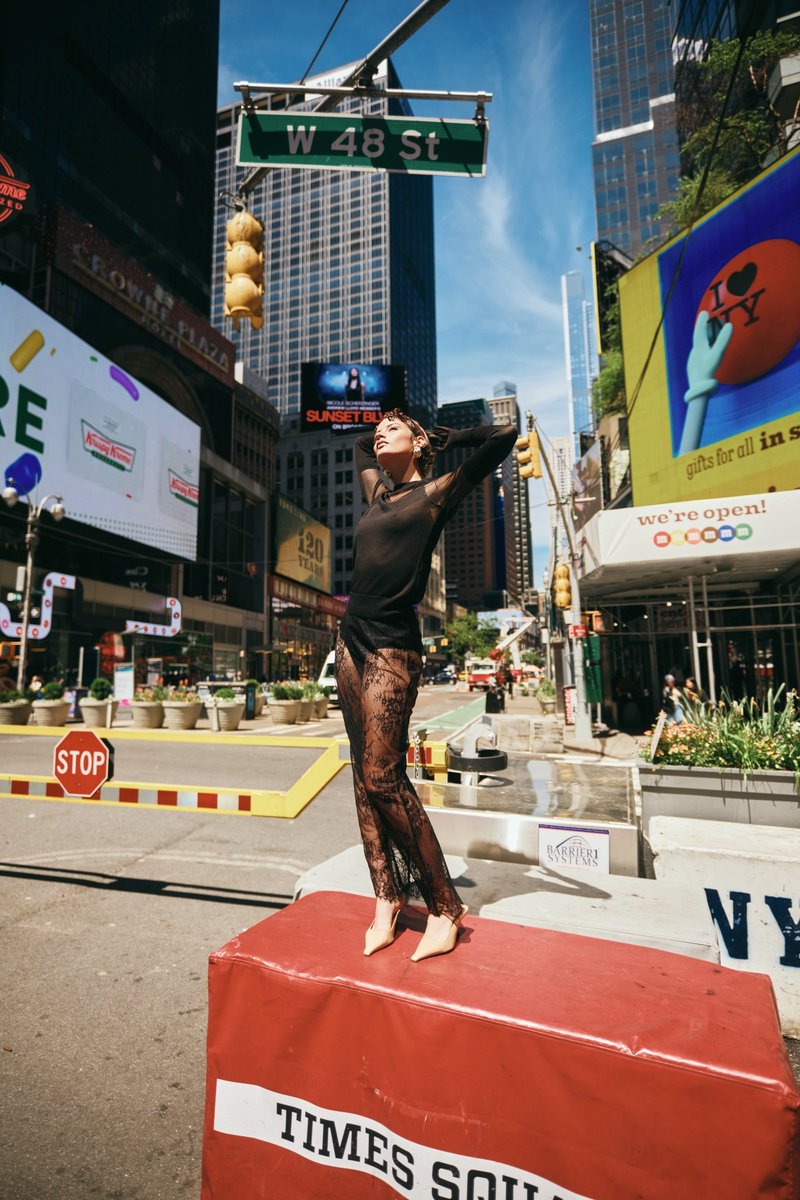 Model Standing on a Barrier in Times Square