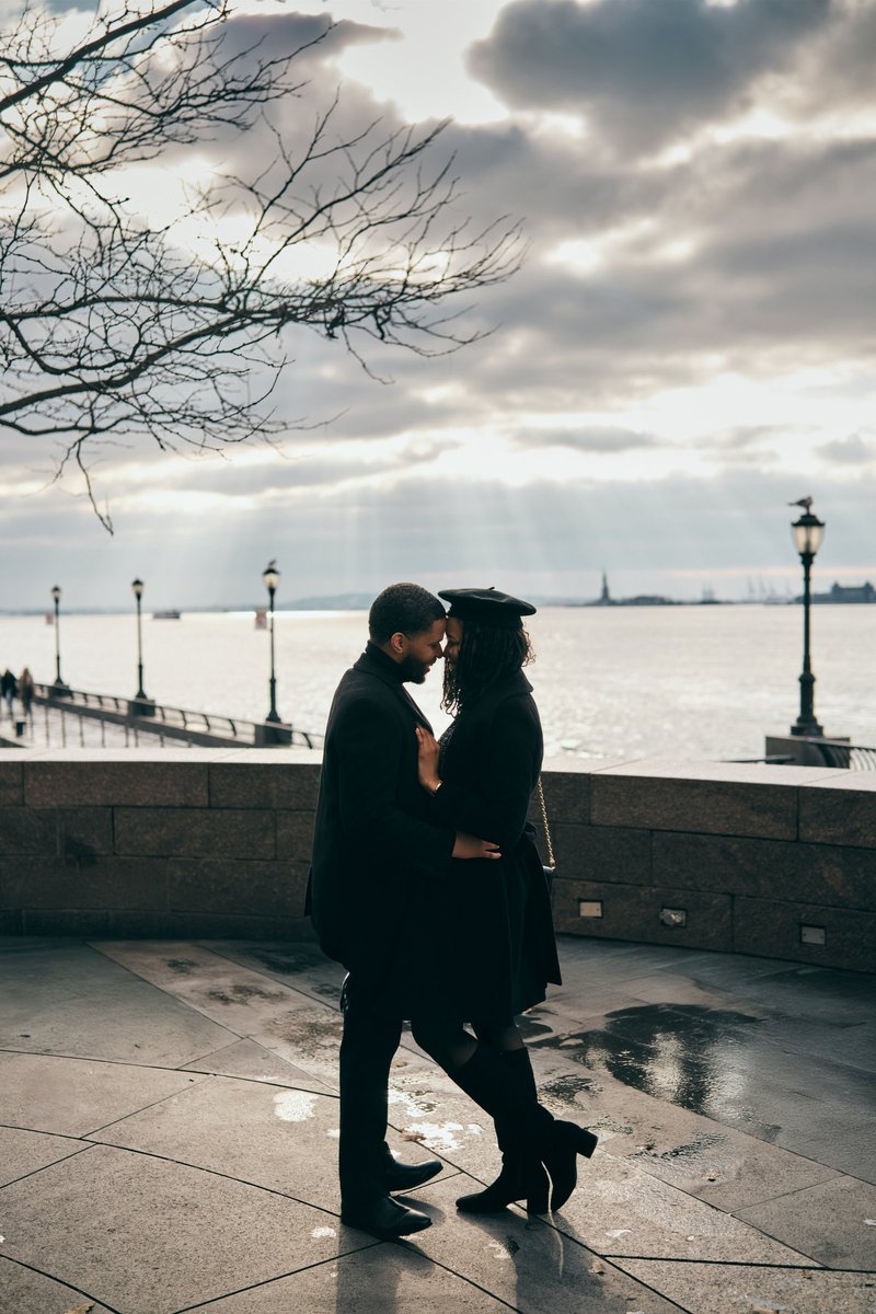 Couple at Battery Park with the Statue of Liberty Beyond