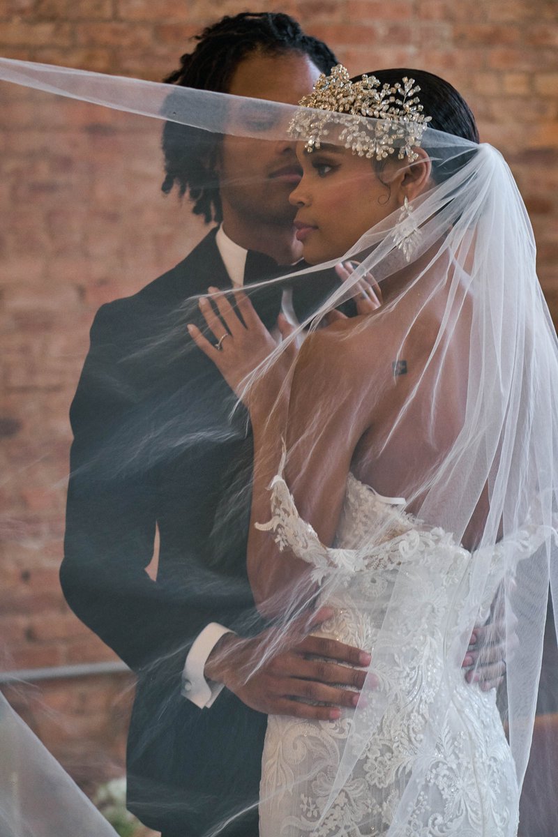 Bride and Groom Embracing Under a Veil