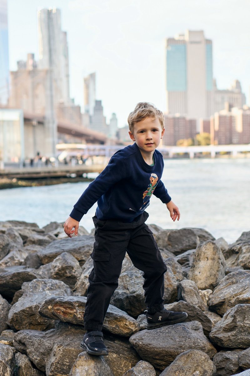 Boy on the Rocks by the Brooklyn Bridge Waterfront